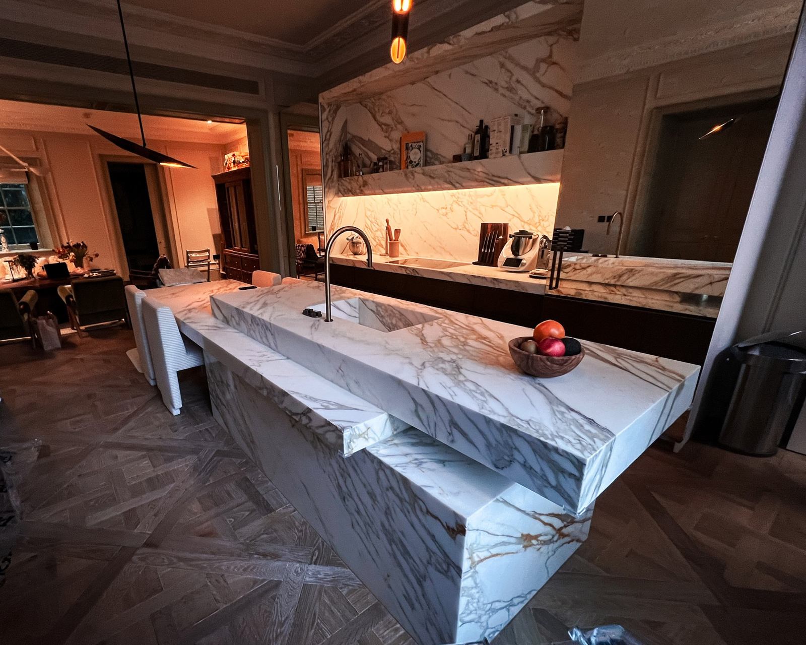 Marble kitchen island with breakfast bar in an open-plan living room